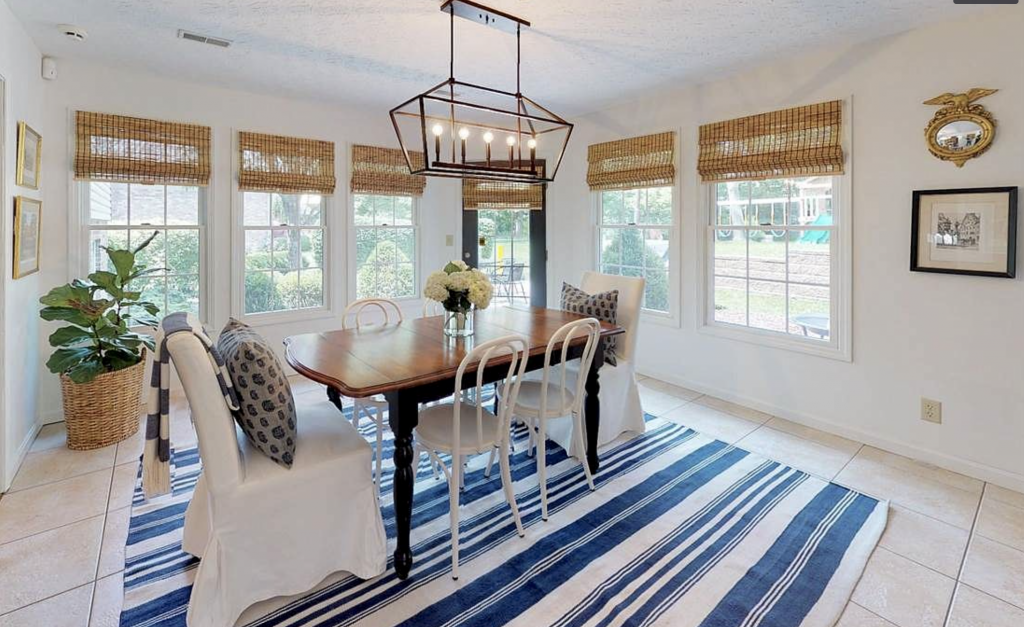 Photo of my old dining room, featuring coastal decor and my favorite affordable window treatment, bamboo shades!